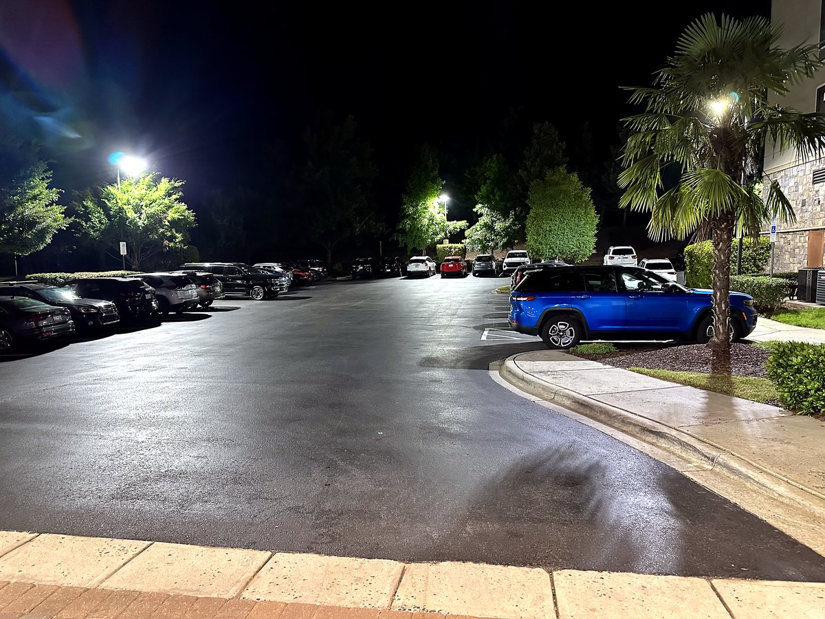 Commercial parking lot with pole lighting at night