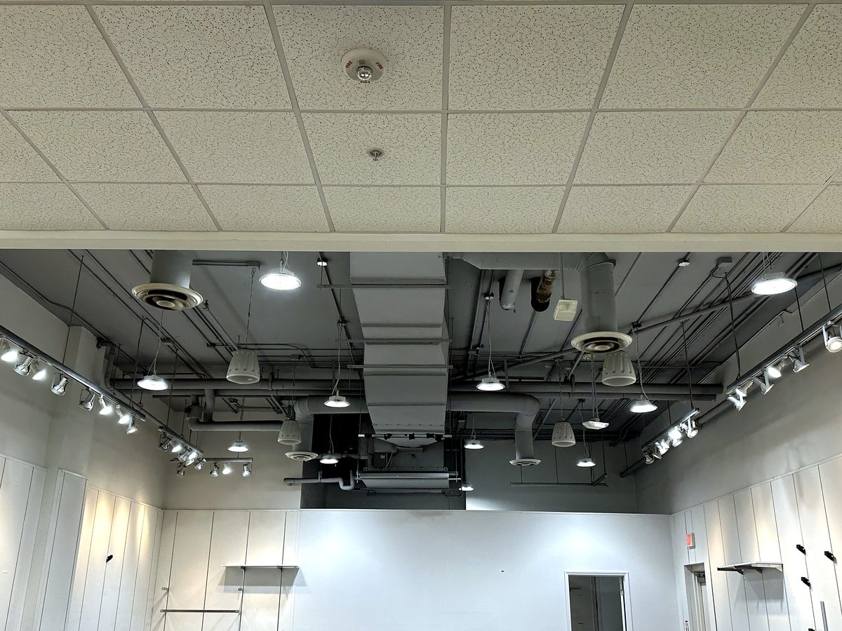 Retail ceiling with track lighting and exposed spiral ductwork