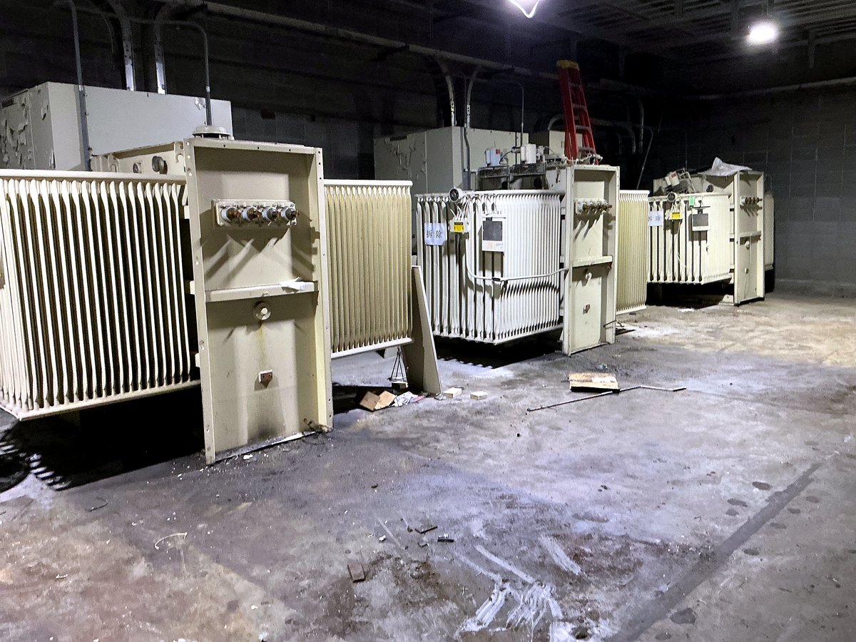 Pad-mount transformer bank in an industrial electrical room